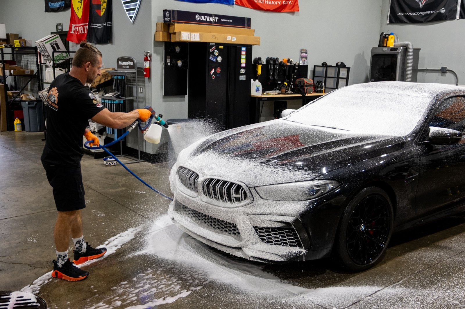 VDS foam pre-wash being applied to a black BMW during preservation maintenance