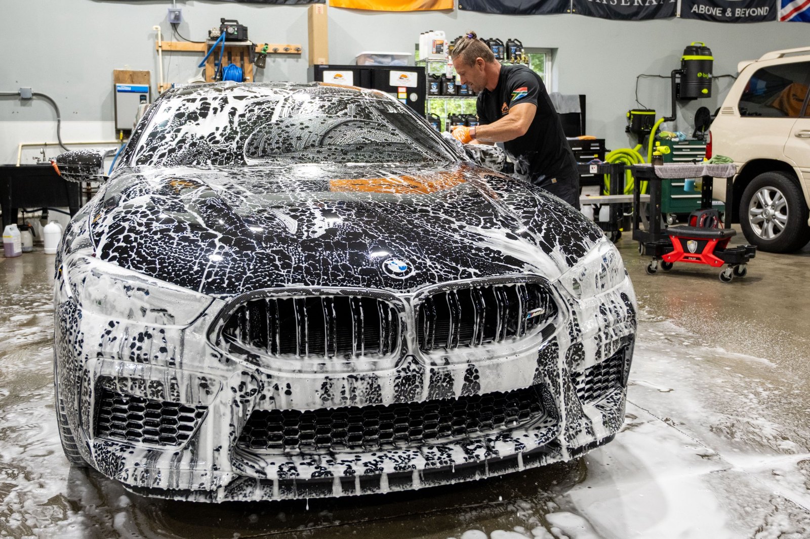VDS hand washing a black BMW during maintenance care